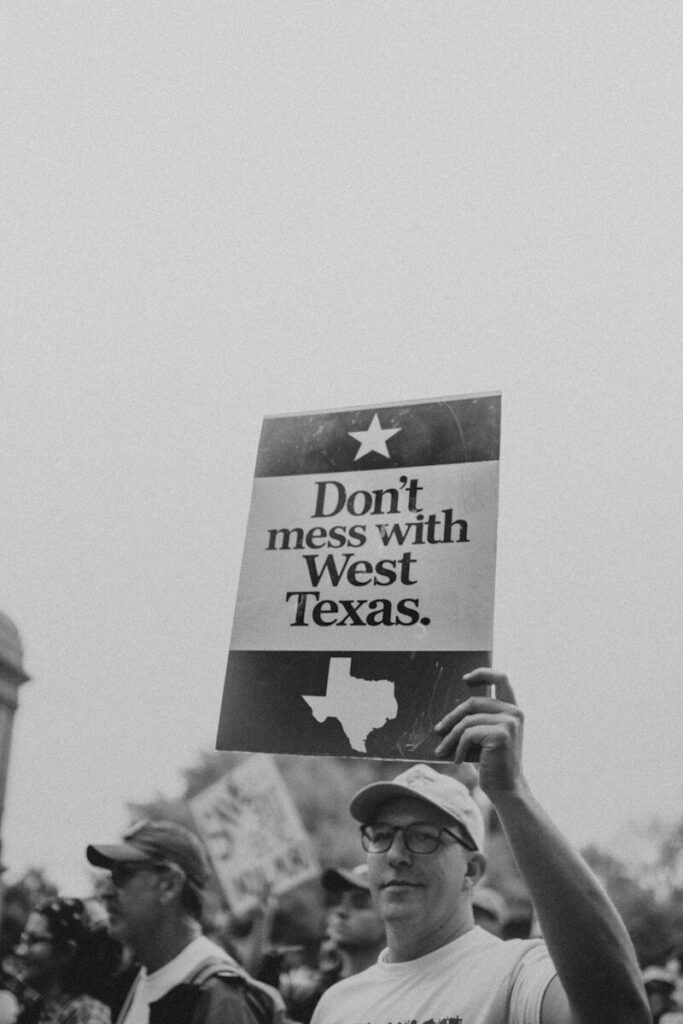 Man holds sign that says don't mess with west texas.